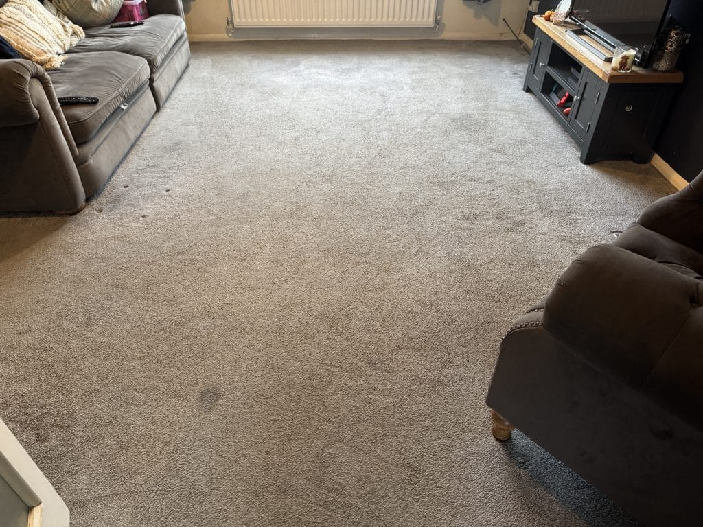 Heavily soiled grey lounge carpet before cleaning in Northampton