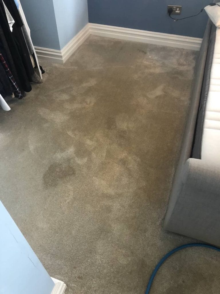 Heavily soiled light-grey bedroom carpet before cleaning in Northampton